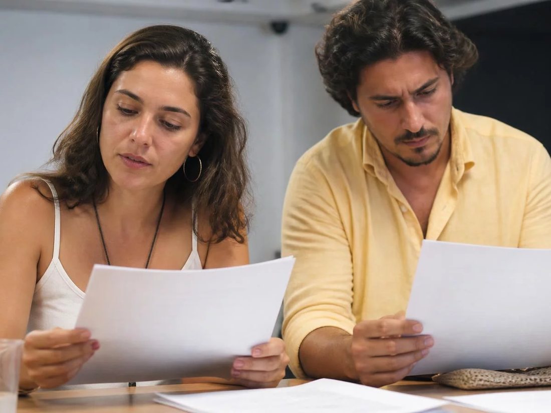 Equipe reunida numa sala clara enquanto uma pessoa explica em pé